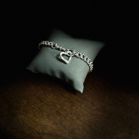 Silver vintage bangle with Lulu and Boo silver molten heart charm.