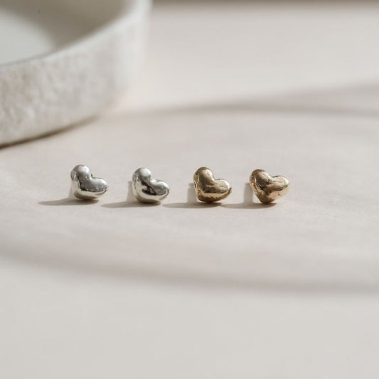 A pair of Puffy Gold Heart Stud Earrings from Lulu and Boo Jewellery.