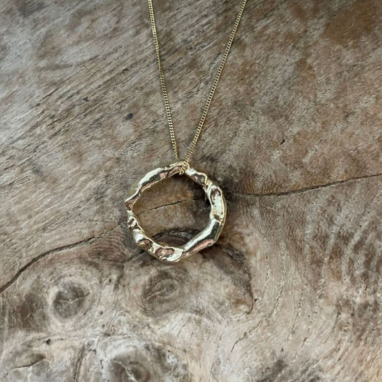 An 18ct Gold Halo Pendant from Lulu and Boo Jewellery.