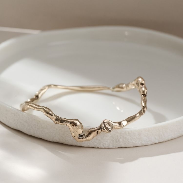 A Wiggle Molten Gold 9ct Bangle from Lulu and Boo Jewellery.