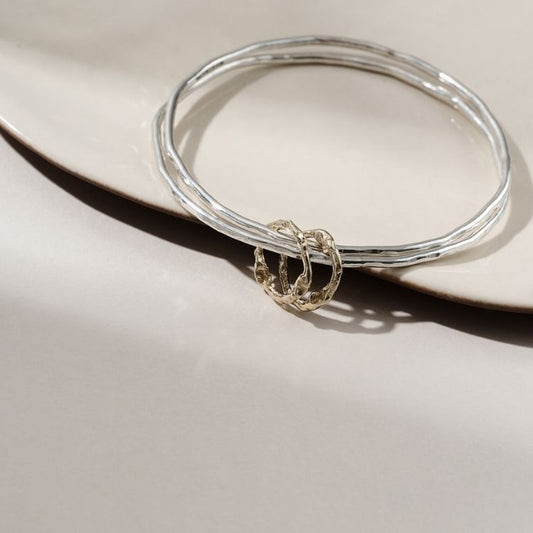 Molten hoops bangle with duo of gold halo charms