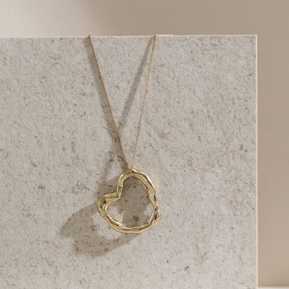 A Large Molten Heart 9ct Gold Necklace from Lulu and Boo Jewellery.