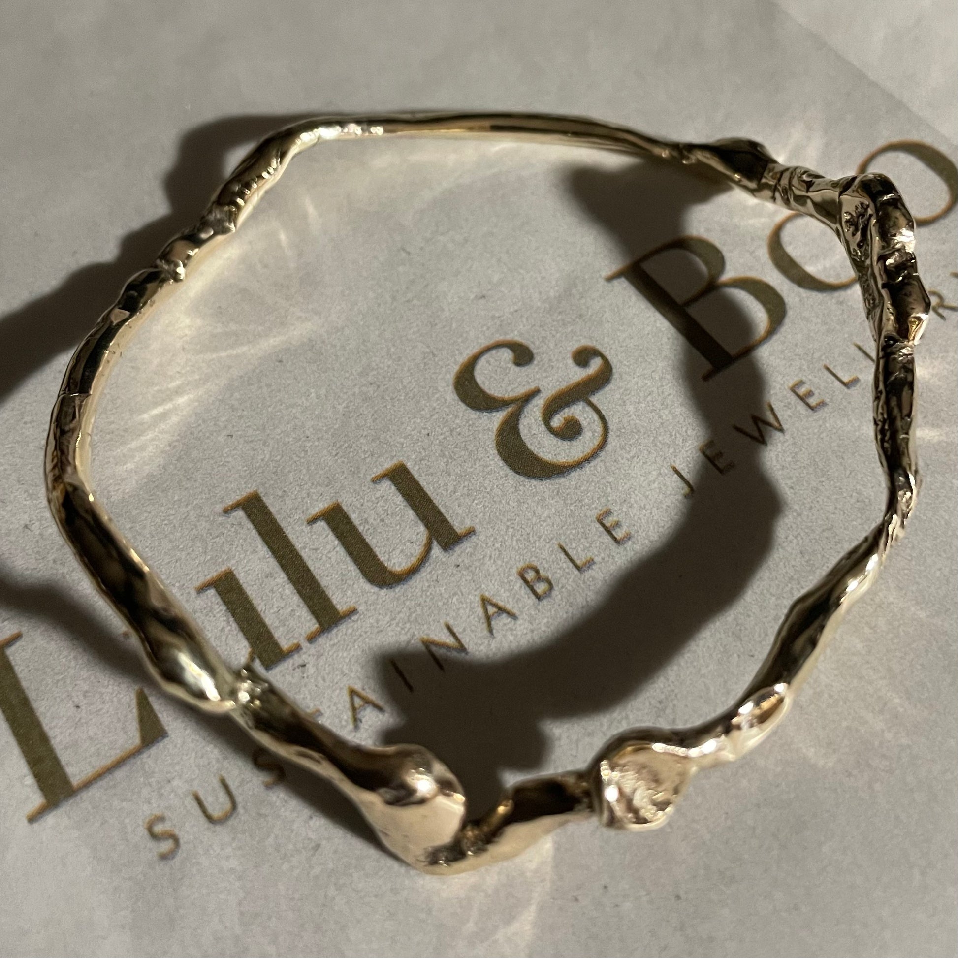 A Wiggle Molten Gold 9ct Bangle from Lulu and Boo Jewellery.